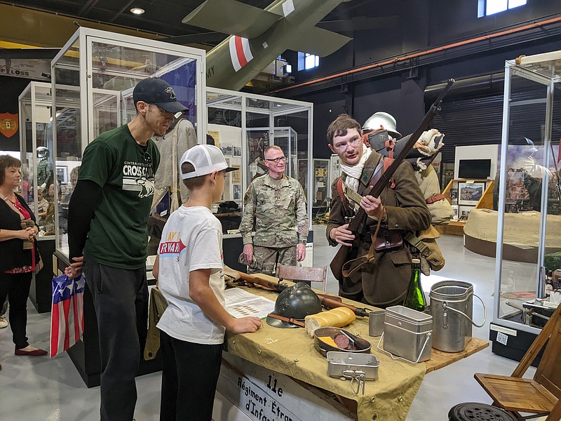 Ryan Pivoney/News Tribune photo: 
Military reenactor Duncan Noack demonstrates to Scott and Charlie Skinner on Sunday, Nov. 6, 2022, how the French military would carry and equip bayonets to their rifles in World War I. Noack was dressed in typical French WWI military garb and explained how different soldiers carried various supplies and equipment.