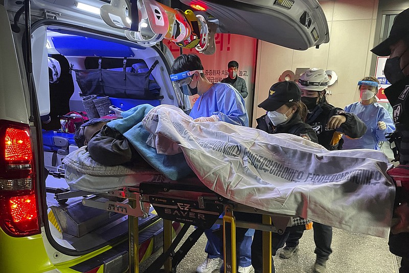 A miner rescued from a collapsed mine is carried into a hospital in Bonghwa, South Korea, Saturday, Nov. 5, 2022. Two South Korean miners rescued after being trapped underground for nine days said they had lived on instant coffee powder and water falling from the ceiling of a collapsed shaft. (Kim Jin-hwan/Yonhap via AP)
