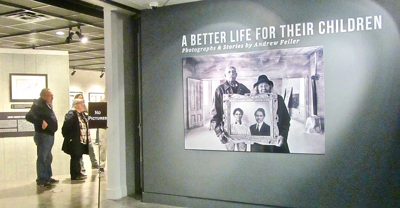 Visitors admire a photograph outside the National Civil Rights Museum gallery displaying “A Better Life for Their Children: Julius Rosenwald, Booker T. Washington and the 4,978 Schools That Changed America.” (Special to the Democrat-Gazette/Marcia Schnedler)