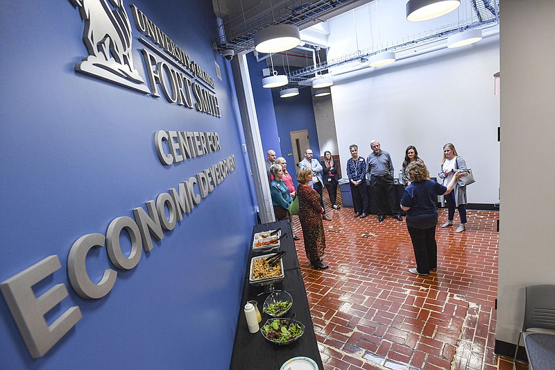 Dr. Kimberly Gordon (front), workforce development coordinator at the University of Arkansas-Fort Smith Center for Economic Development, guides a tour, Wednesday, Nov. 9, 2022, for secondary career center technical directors across Arkansas inside the center at the Bakery District in downtown Fort Smith. The center has partnered with the Arkansas Small Business and Technology Development Center and the  Fort Smith-based nonprofit organization 64.6 Downtown to host the fifth annual Invest Fort Smith summit on Nov. 16. Visit nwaonline.com/221113Daily/ for today's photo gallery.
(NWA Democrat-Gazette/Hank Layton)