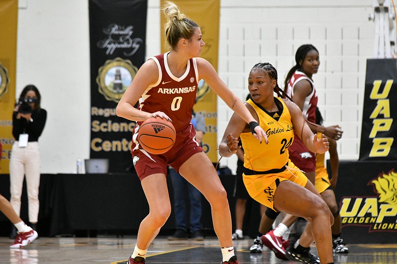 Saylor Poffenbarger of Arkansas runs the point against Raziya Potter of UAPB in the first quarter Monday at H.O. Clemmons Arena. (Pine Bluff Commercial/I.C. Murrell)