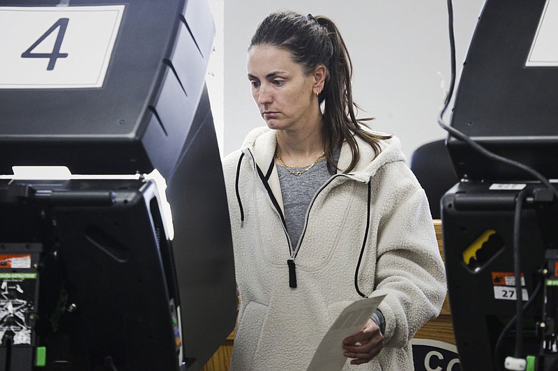 Lindsey Robers finishes voting, Monday, November 7, 2022 during early voting at the Benton County Administration Building in Bentonville. Visit nwaonline.com/221108Daily/ for today's photo gallery.

(NWA Democrat-Gazette/Charlie Kaijo)