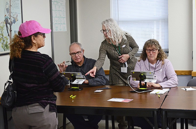 Eileen Wisniowicz/News Tribune photo: 
From left, Dora Vargas waits for a ballot from Perry Mathes, Cherri Williams, and Leona Duren on Tuesday, Nov. 8, 2022 at Missouri Electric Co-Op Employee's Credit Union in Jefferson City.