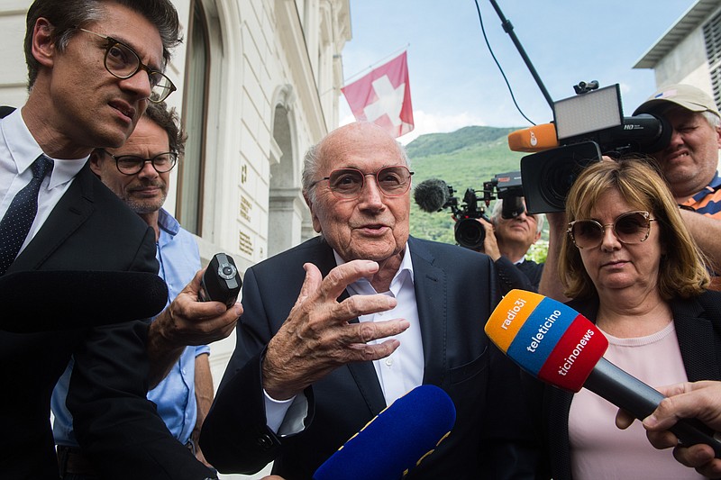 FILE -  Former FIFA president Sepp Blatter is surrounded by the media as he leaves the Swiss Federal Criminal Court in Bellinzona, Switzerland, Wednesday, June 8, 2022. Blatter said on Tuesday, Nov. 8, 2022, that picking Qatar to host the World Cup was a mistake 12 years ago. (Alessandro Crinari/Keystone via AP, File)