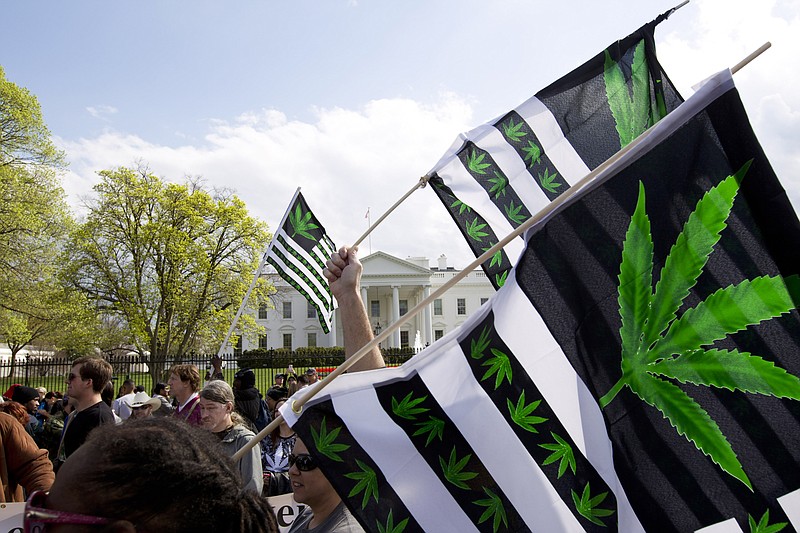 FILE - A demonstrator waves a flag with marijuana leaves depicted on it during a protest calling for the legalization of marijuana, outside of the White House on April 2, 2016, in Washington. Voters in five states are deciding on Election Day whether to approve recreational marijuana. The proposals going before voters in Arkansas, Maryland, Missouri, North Dakota and South Dakota on Tuesday could signal a major shift toward legalization in even the most conservative parts of the country.  (AP Photo/Jose Luis Magana, File)