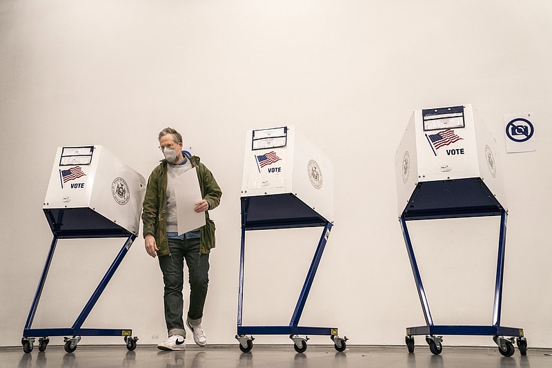 A voter moves to cast their vote after filling out their ballot at a polling site inside The Shed arts center, Tuesday, Nov. 8, 2022, in the Hudson Yards neighborhood of the Manhattan borough of New York. (AP Photo/John Minchillo)