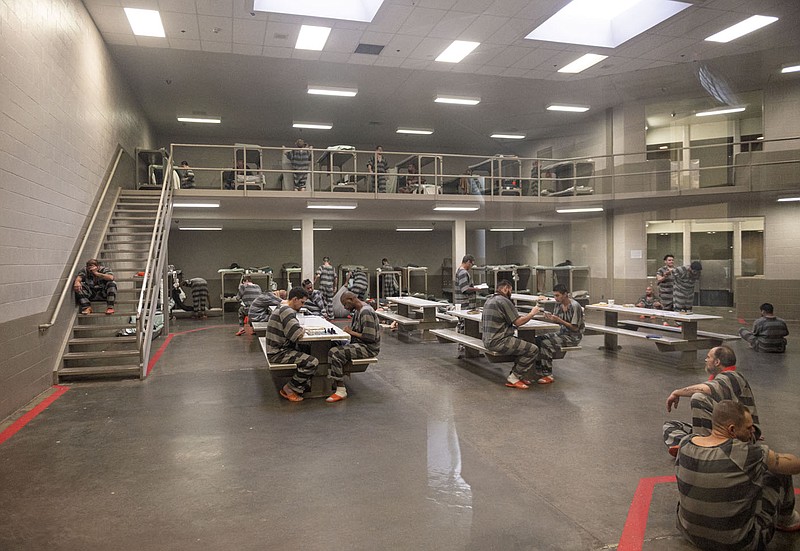 Inmates at the Benton County Jail sit in D Block on Oct. 14 in Bentonville. Voters went to the polls Tuesday to decide whether to expand the jail because of overcrowding.
(File photo/NWA Democrat-Gazette/Spencer Tirey)