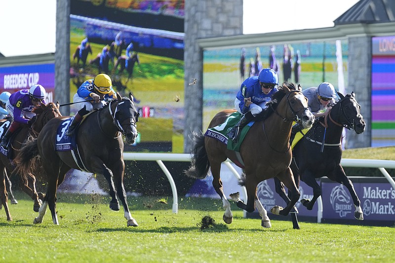 William Buick rides Mischief Magic (5) to victory past Ryan Moore on Dramatised (4) and Joel Rosario riding Private Creed (3) during the Breeders' Cup Juvenile Turf Sprint race at the Keenelend Race Course Friday in Lexington, Ky.  - Photo by Jeff Roberson of The Associated Press