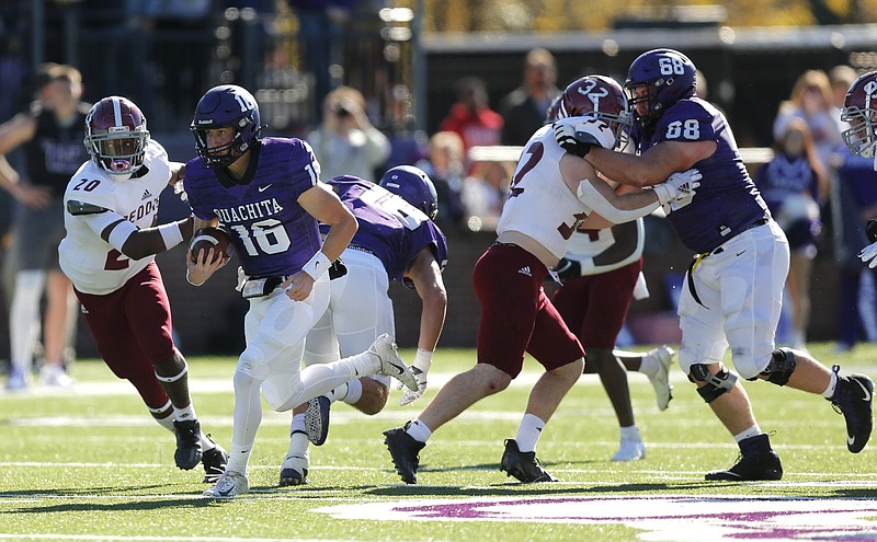 Ouachita Baptist quarterback Grant Allen (16) races past Henderson State defensive back Patrick Jones (20) for a 52-yard touchdown during the first quarter of OBU's 31-28 win in the Battle of the Ravine on Nov. 13, 2021, at Cliff Harris Stadium in Arkadelphia. - Photo by Thomas Metthe of Arkansas Democrat-Gazette