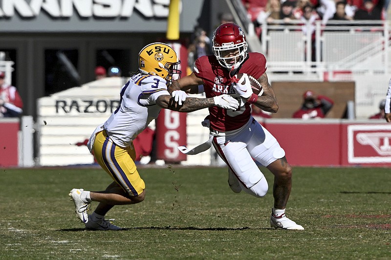 Arkansas wide receiver Jadon Haselwood (9) tries to shake LSU safety Greg Brooks Jr. (3) as he runs for a gain during the first half Saturday in Fayetteville. - Photo by Michael Woods of The Associated Press