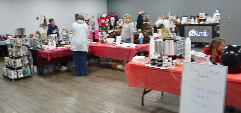 Westside Eagle Observer/SUSAN HOLLAND Shoppers browse through booths at the Mistletoe Market held Saturday, Nov. 12, at the Gravette Civic Center. Twenty area vendors offered a wide variety of products, including clothing, beauty products, foodstuffs, home decor, yard ornaments, and gift items. Door prizes were given, and a hot cocoa bar sold cocoa and fried Oreos. Organizer Felicia Stark said a similar market is planned again next year.