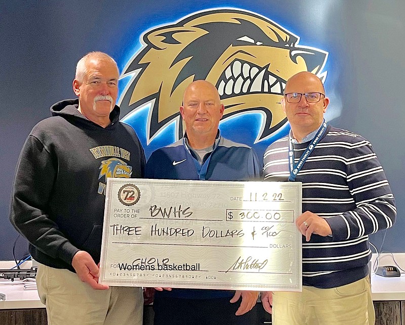 Submitted Photo
Steve Mitchael (left), owner of 72 West, presents a check for $300 for the women's basketball program at Bentonville West High School. Shown accepting the donation are Dion Hargrove, BWHS women's basketball coach, and BWHS principal Jonathon Guthrie.