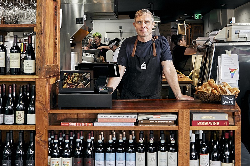 Kevin Smith, the owner of Beast and Cleaver, a butcher shop poses in the store in Seattle on June 13, 2022. Higher prices are hitting everyone this holiday, but food vendors are seeing some of the biggest increases. (Amber Fouts via AP)