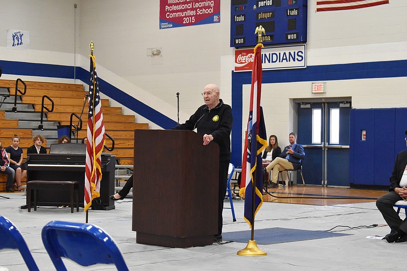 Democrat photo/Garrett Fuller — Retired Lt. Col. James Schaffner, a World War II and Korean War veteran, speaks about honoring all military members, including those not serving on the front lines, during the Veterans Day assembly at Cole R-I High School in Russellville.
