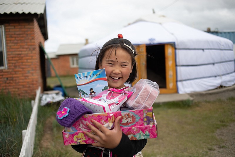 A girl smiles in Mongolia after receiving a shoebox full of gifts from Operation Christmas Child. (Photo by Samaritan's Purse)