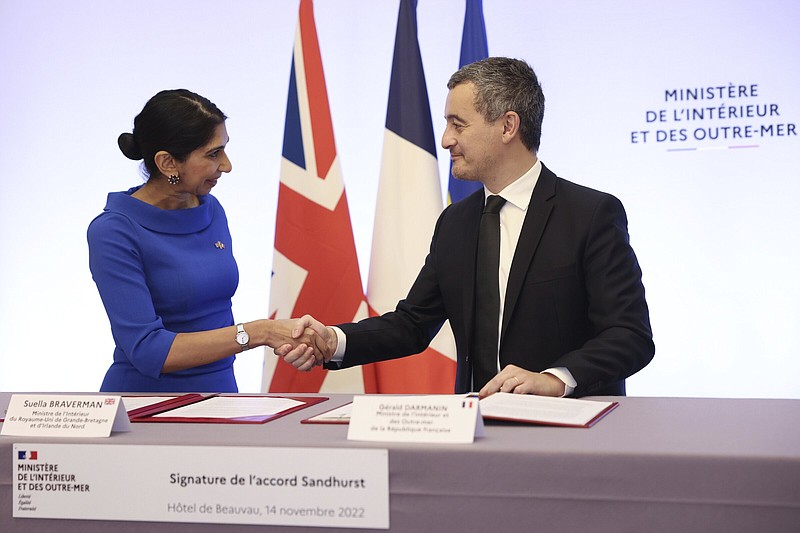 French Interior Minister Gerald Darmanin and Britain's Home Secretary Suella Braverman shake hands as they sign a joint declaration at the French Interior Ministry in Paris, Monday, Nov. 14, 2022. Suella Braverman and French Interior Minister Gerald Darmanin will sign a joint declaration revising the "Sandhurst Treaty" border security deal which aims to curb migrant Channel crossings. (Thomas Samson, Pool via AP)