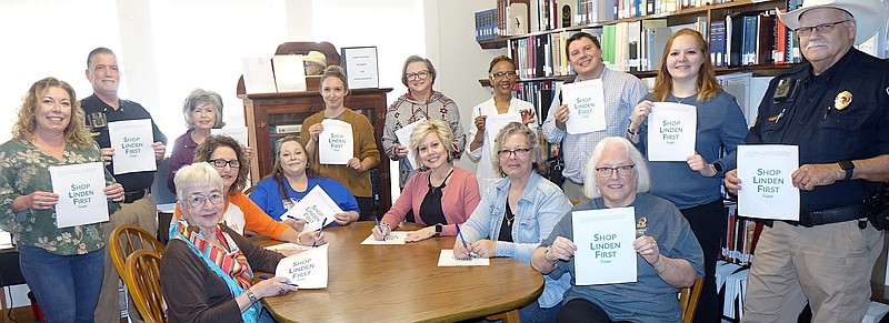 The 15 people have big smiles because they’ve signed a challenge to Shop Linden First with at least a 10 percent level. Standing from left, they are Rebecca Elliott, David Dulude, Mary Dowd, Allie Anderson, Judy Lanier, Flo Stephenson, Lee Elliott, Megan Kirkland and Kevin Frazier. Seated, Rebecca Narramore, Carla Surratt, Sandra Johnson-Langford, Tanya Bond, Lisa Creamer and Denise Haas. (Photo by Neil Abeles)