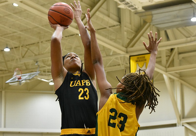 Maori Davenport of UAPB powers up for a shot over Dasia Turner of Philander Smith in the first quarter Tuesday at H.O. Clemmons Arena. (Pine Bluff Commercial/I.C. Murrell)