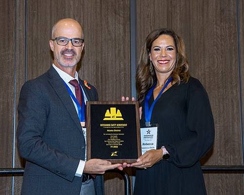 Rebecca Wells, right, accepts the Outstanding Safety Achievement Award from Texas Department of Transportation Executive Director Marc Williams in October at Transportation Short Course 2022 in College Station, Texas. Wells is district engineer for TxDOT's Atlanta District (Submitted photo)