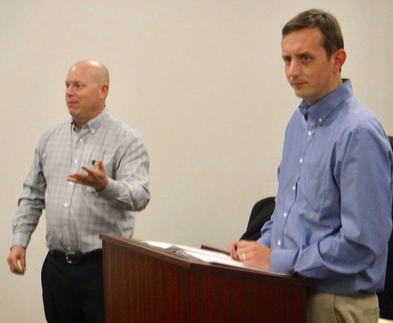 Westside Eagle Observer/SUSAN HOLLAND Tim Reavis (right), regional planner, listens as Tim Conklin, assistant director of the Northwest Arkansas Regional Planning Commission, speaks to members of the Gravette Planning Commission. Both Reavis and Conklin were guests at the commission meeting Tuesday, Nov. 15, and offered suggestions for updating Gravette’s comprehensive plan.