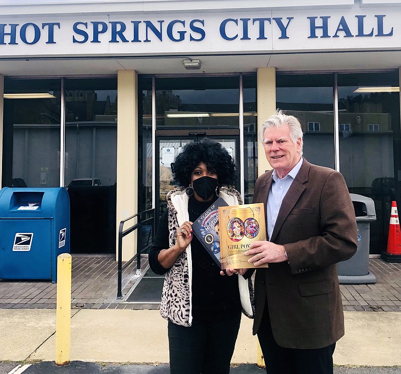 Little Rock author Phyllis Hodges is shown with Hot Springs Mayor Pat McCabe, who is holding her two books, “8 Years of Unforgettable History” and “Girl Power,” outside of Hot Springs City Hall. - Submitted photo