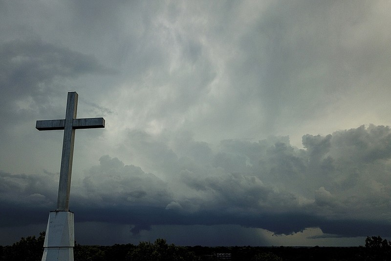 Storm clouds approach a church Sunday, Aug. 2, 2020, in Mequon, Wis. A new Pew Research Center report published Thursday, Nov. 17, 2022, explores how religion in the U.S. intersects with views on the environment and climate change. (AP Photo/Morry Gash)