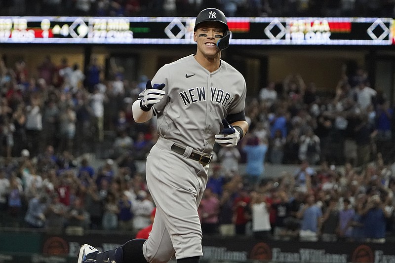 FILE -  New York Yankees' Aaron Judge gestures as he runs the bases after hitting a solo home run, his 62nd of the season, during the first inning in the second baseball game of a doubleheader against the Texas Rangers in Arlington, Texas, Tuesday, Oct. 4, 2022. With the home run, Judge set the AL record for home runs in a season, passing Roger Maris. Judge won the American League MVP Award on Thursday, Nov. 17, 2022, in voting by a Baseball Writers' Association of America panel. (AP Photo/LM Otero, File)