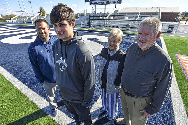 Chris Young (from left), head coach of the Greenwood High School football team, poses Wednesday with his son, Cooper Young, and his parents, Catherine Young and Joe Fred Young, at Smith-Robinson Stadium in Greenwood. Visit nwaonline.com/221120Daily/ for today’s photo gallery.

(NWA Democrat-Gazette/Hank Layton)