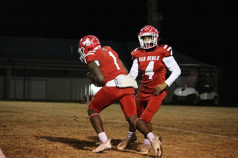 Mountain Pine's Keelan Dobbins (4) hands the ball off to Isaiah Miles (1) against Rector Friday at Stanley May Field. - Photo by Krishnan Collins of The Sentinel-Record