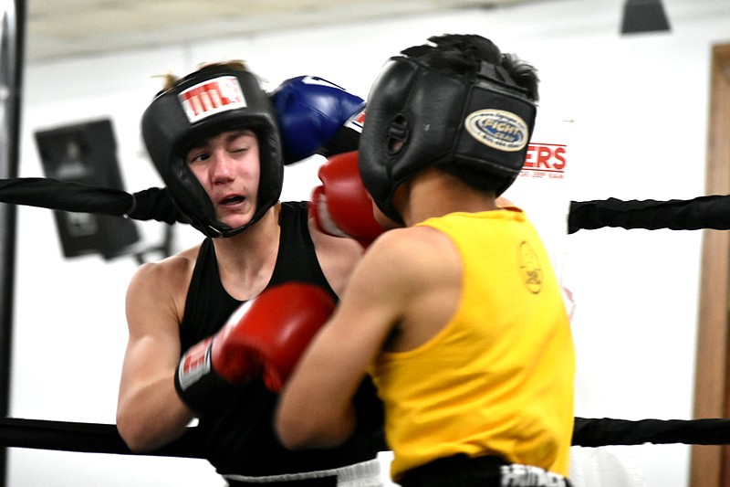 Jay Parga, right, of Springdale delivers a blow to Garrin Smith of Augusta in one of Saturday's state Silver Gloves matches at the Sahara Temple. Parga won by decision. (Pine Bluff Commercial/I.C. Murrell)