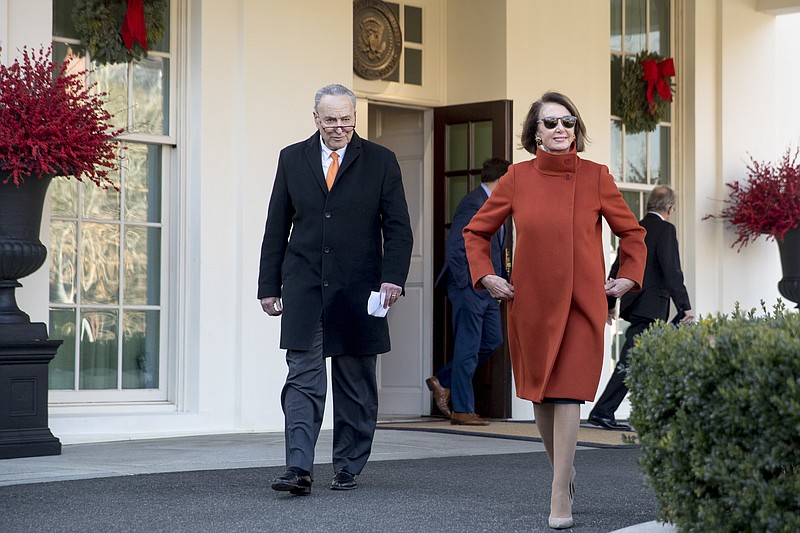 FILE - House Minority Leader Nancy Pelosi of Calif., right, and Senate Minority Leader Sen. Chuck Schumer of N.Y., left, walk out of the West Wing to speak to members of the media outside of the White House in Washington, Dec. 11, 2018, following a meeting with President Donald Trump. Pelosi's decision to step down from Democratic leadership after 20 years has many women admiring the way she wielded power. (AP Photo/Andrew Harnik, File)