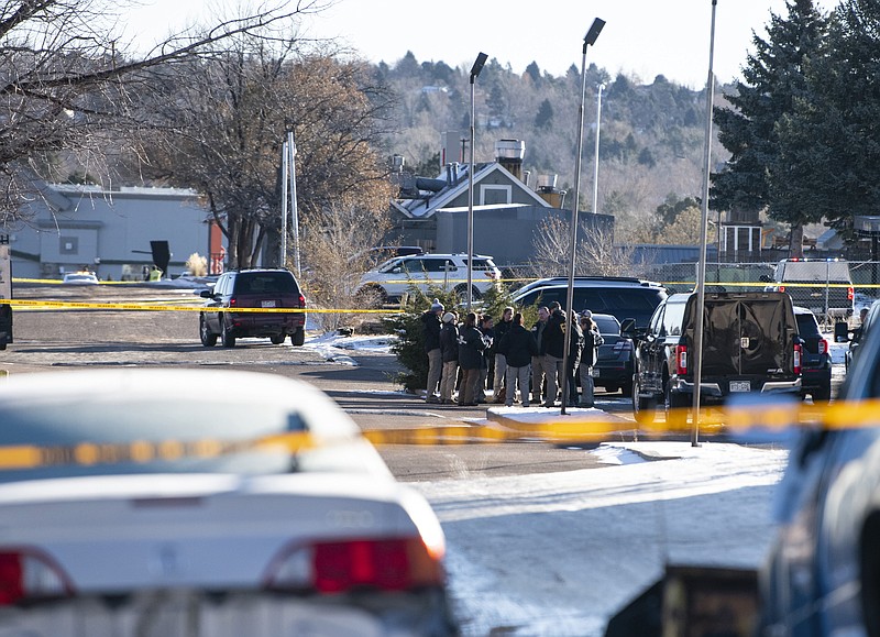 Law enforcement personnel stand outside of the scene of a mass shooting at Club Q, a gay bar in Colorado Springs, Colo., on Sunday, Nov. 20, 2022. A 22-year-old gunman opened fire in the gay nightclub, killing at least five people and leaving multiple others injured before he was subdued by &#x201c;heroic&#x201d; patrons and arrested by police who were on the scene within minutes, authorities said Sunday. (Parker Seibold/The Gazette via AP)