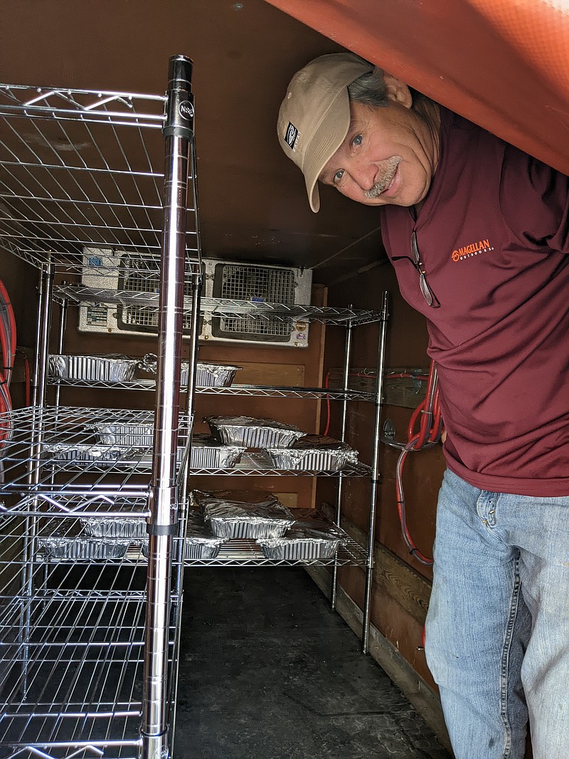 Ryan Pivoney/News Tribune photo: 
Mike Schnieders loads pans of prepared turkey into a donated refrigerated trailer Sunday, Nov. 20, 2022, at Immaculate Conception Catholic Church in Jefferson City. Schnieders and more than a dozen other volunteers cooked and broke down 50 turkeys Sunday for the church's 14th annual Thanksgiving Day community meal.