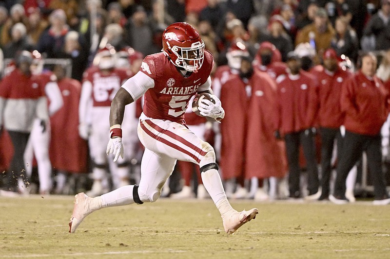Arkansas running back Raheim Sanders (5) breaks away from the Ole Miss defense to score a touchdown during the first half Saturday in Fayetteville. - Photo by Michael Woods of The Associated Press