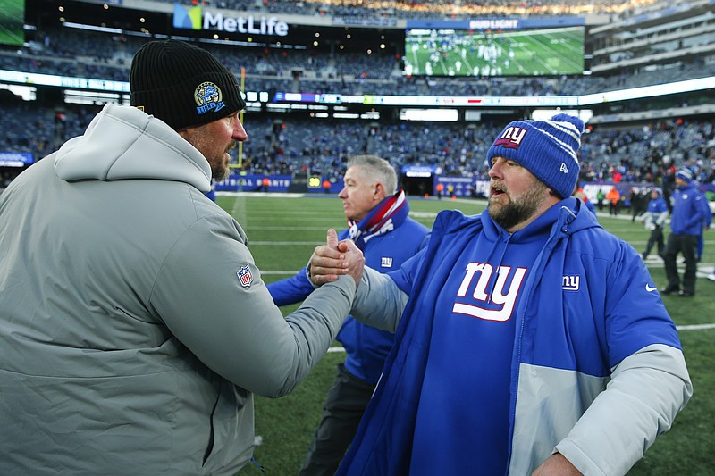 Detroit Lions head coach Dan Campbell runs off the field after the