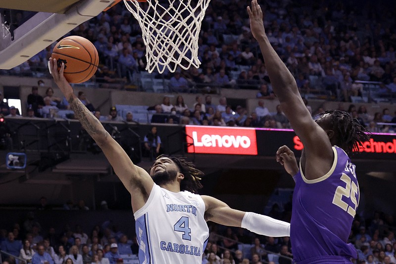 North Carolina guard R.J. Davis (4) drives to the hoop against James Madison forward Alonzo Sule (25) during the first half of an NCAA college basketball game Sunday, Nov. 20, 2022, in Chapel Hill, N.C. (AP Photo/Chris Seward)