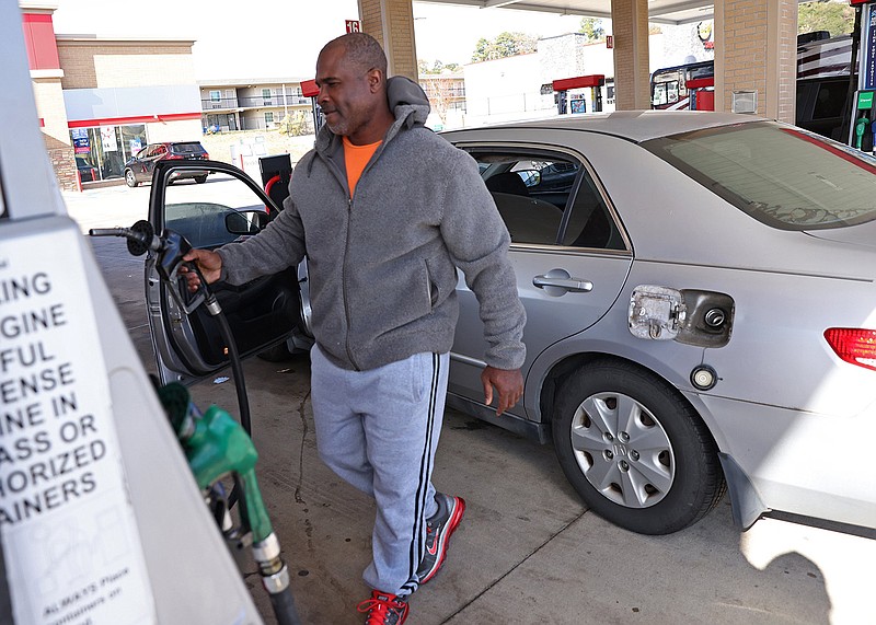 Sam Khaveer fills up his car at the Murphy Express gas station on West Pershing Boulevard in North Little Rock on Monday, Nov. 21, 2022. (Arkansas Democrat-Gazette/Colin Murphey)