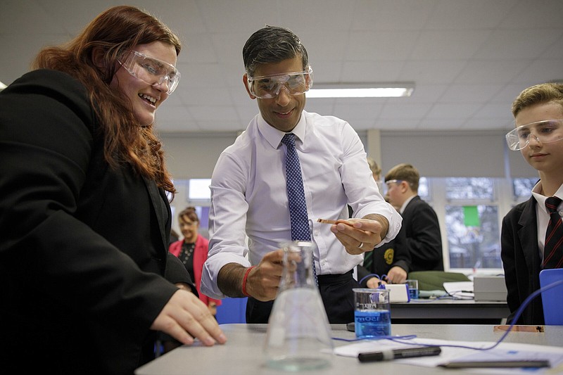 Britain's Prime Minister Rishi Sunak participates in a chemistry class during a visit to the Erasmus Darwin Academy in Burntwood, Staffordshire, Monday Nov. 21, 2022. (Andrew Fox/Pool via AP)