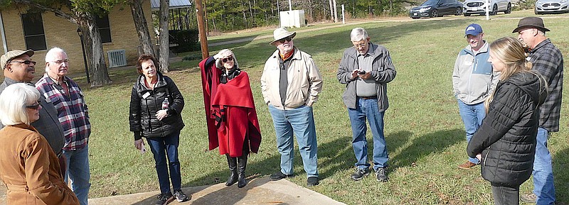 At left, Sue Lazara and Mason Barrett both of Linden, greet members of Preservation Texas’ board of directors and staff who have come to visit the Macedonia rock school. From left, the board members are Ron Siebler of Dallas, Kate Johnson of Kyle, Dixie Hoover of Mexia, Charles John of San Antonio and Willis Winters of Mineral Wells. Next are staff member and executive director Evan Thompson of San Marcos and staff member and communications manager Samantha Hunick of San Marcos. At the far right is board member Derrick Birdsall of Huntsville. (Photo by Neil Abeles)