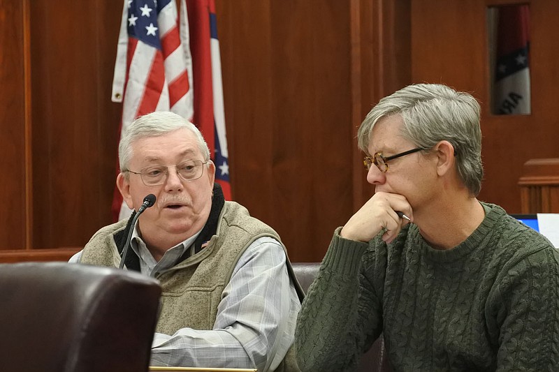 Crawford County Judge Dennis Gilstrap, left, presents a report while Mark Shaffer, county justice of the peace for District 6, right, listens during the county Quorum Court meeting Monday. 
(NWA Democrat-Gazette/Thomas Saccente)