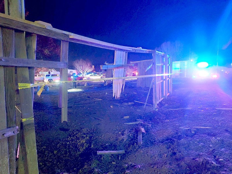 Yellow caution tape is stretched across a broken fence where a truck apparently broke through Tuesday night at Lake Hamilton RV Resort, 3027 Albert Pike Road. - Photo by Donald Cross of The Sentinel-Record