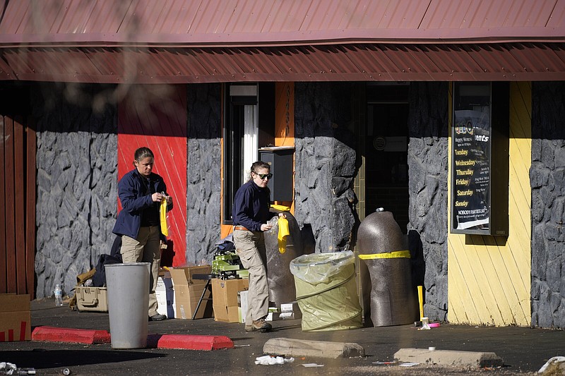 Law enforcement investigators enter Club Q, the site of a weekend mass shooting, on Tuesday, Nov. 22, 2022, in Colorado Springs, Colo.   Anderson Lee Aldrich opened fire at Club Q, in which five people were killed and others suffered gunshot wounds before patrons tackled and beat the suspect into submission.   (AP Photo/David Zalubowski)