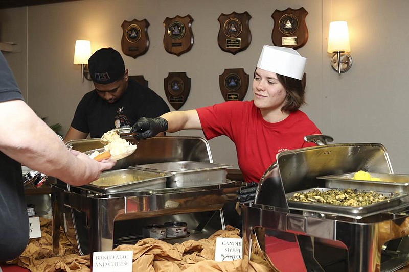 Airman Samantha Fraleypineda, from Rogers, serves mashed potatoes for a Thanksgiving dinner aboard the Nimitz-class aircraft carrier USS Abraham Lincoln (CVN 72). Abraham Lincoln is currently moored pier side at Naval Air Station North Island in support of routine operations.

(U.S. Navy photo by Mass Communication Specialist 3rd Class Brandon Pitts)