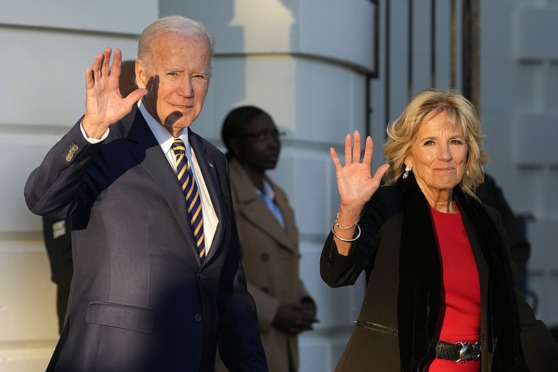 President Joe Biden and first lady Jill Biden wave as they walk to Marine One on the South Lawn of the White House, Monday, Nov. 21, 2022, in Washington. The Bidens are en route to North Carolina. (AP Photo/Alex Brandon)