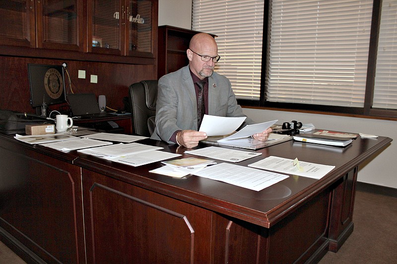 Chief Michael Kramm reviews paperwork in his office Wednesday, Nov. 16, 2022, at Texarkana Arkansas Police Department in the Bi-State Justice Center in downtown Texarkana. Kramm assumed command on Oct. 24, 10 months after retiring as an assistant city manager in League City, Texas. (Staff photo by Stevon Gamble)