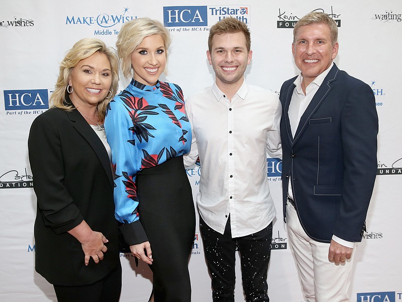 Julie Chrisley (left), Savannah Chrisley, Chase Chrisley and Todd Chrisley are shown in a 2018 file photo. The parents are going to prison and Savannah is sad on her latest podcast. (Getty Images for The Kevin Carter Foundation/TNS/Terry Wyatt)