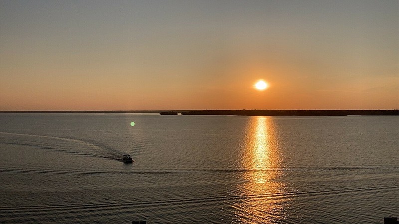 A fishing boat is pictured at Wright Patman Lake while the sun sets in the distance. (Submitted photo)