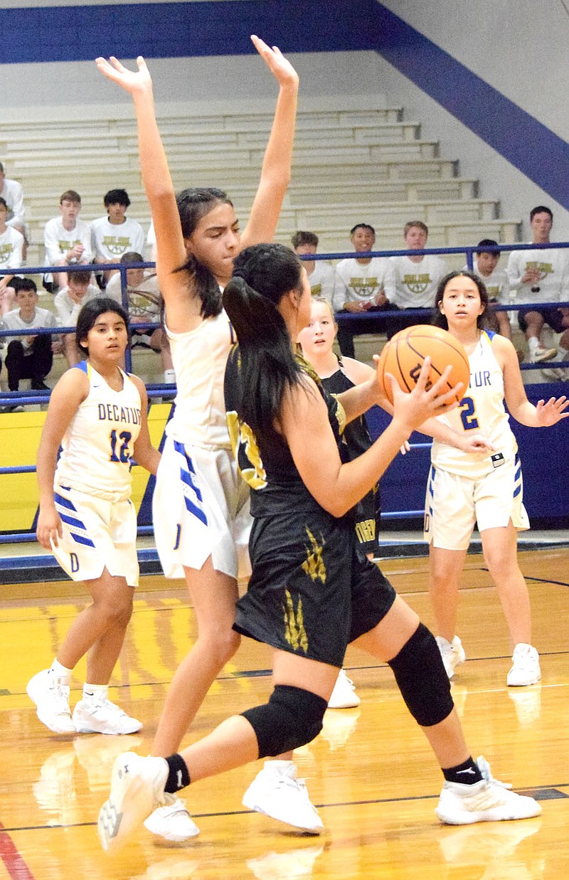Westside Eagle Observer//MIKE ECKELS
Lady Bulldog Daisy Fuentes (center, left) puts up a block that forces a Lady Tiger away from the basket during the Decatur-West Fork junior high girls basketball contest in Decatur Nov. 21.
