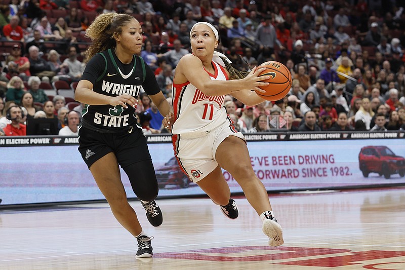 Ohio State's Kaia Henderson, right drives the lane against Wright State's Makiya Miller during the second half of an NCAA college basketball game on Wednesday, Nov. 23, 2022, in Columbus, Ohio. (AP Photo/Jay LaPrete)