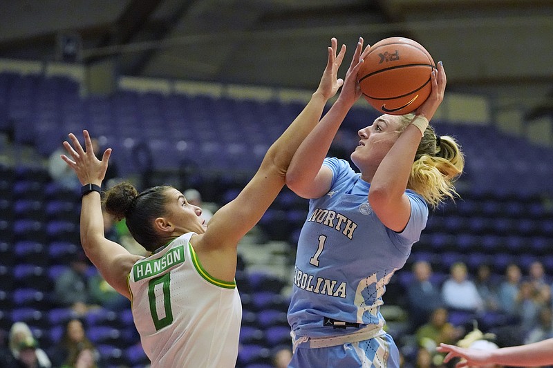 Oregon guard Taya Hanson (0) defends against North Carolina guard Alyssa Ustby (1) during the first half of an NCAA college basketball game in the Phil Knight Invitational tournament Thursday, Nov. 24, 2022, in Portland, Ore. (AP Photo/Rick Bowmer)